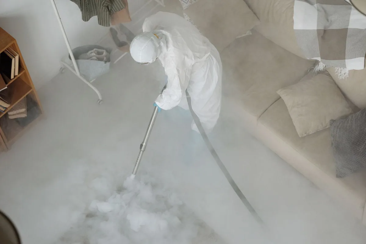 Biohazard cleanup technician in protective equipment, Celeste, TX